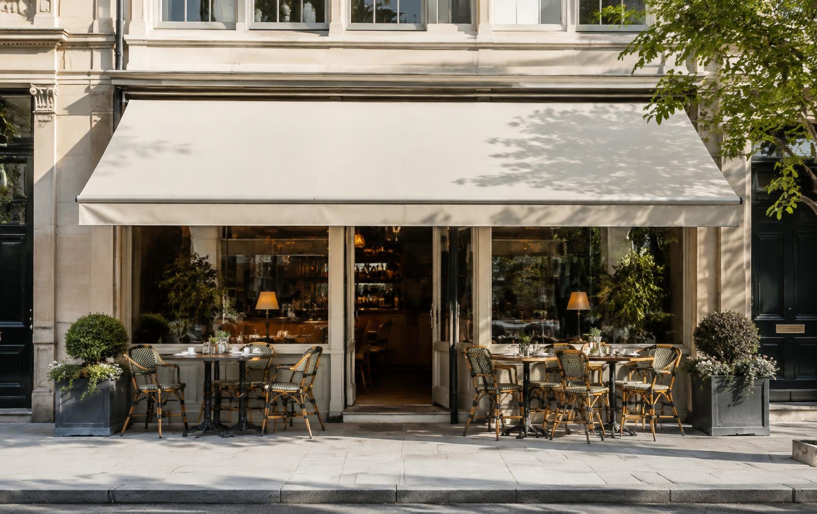 Café frontage with extended retractable awning over pavement seating