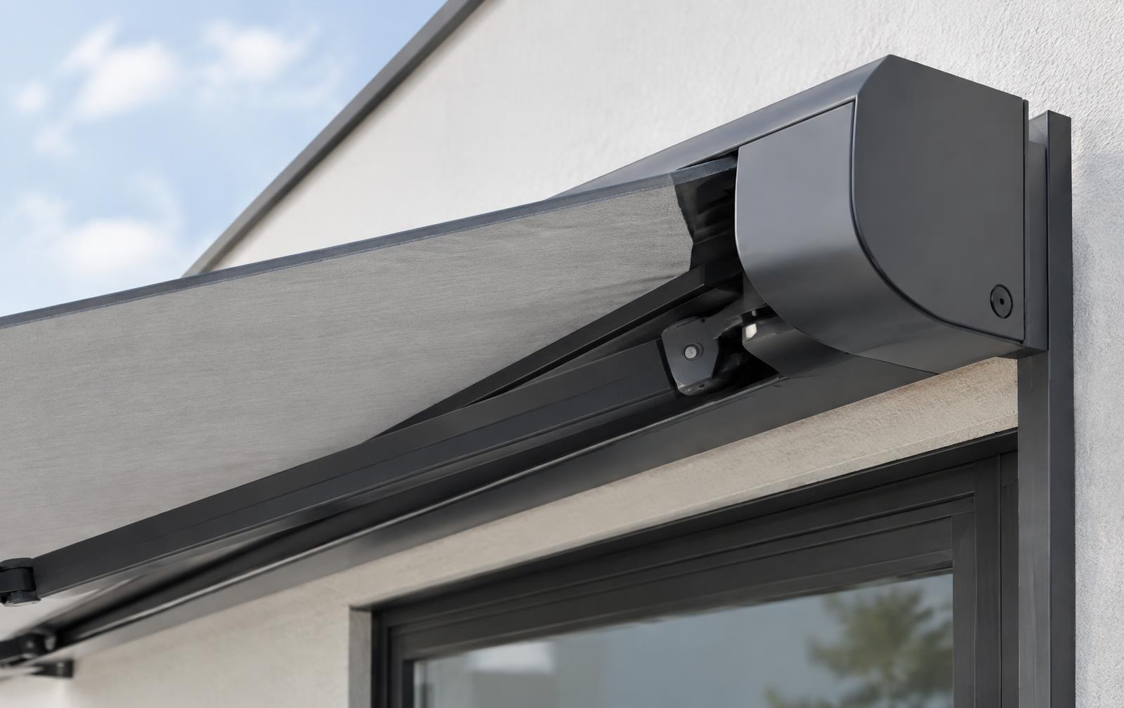 Commercial cassette retractable awning partially extended from a building façade